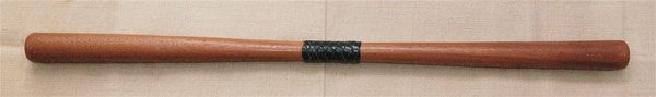 Wooden devil stick with a decorative Turks head whipping centre grip in flat section leather