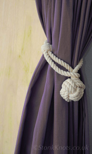 Monkey fist and loop rope curtain tieback on curtain