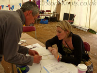 Learning to tie a bracelet in coloured cotton cord, Isle of Wight 2012
