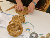 Finishing a Turks' Head rope mat (background); display ropecraft Turk's Head manila basket (foreground), Isle of Wight 2012