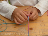 Tying a sennit bracelet in coloured cotton cord, Hesfes 2012